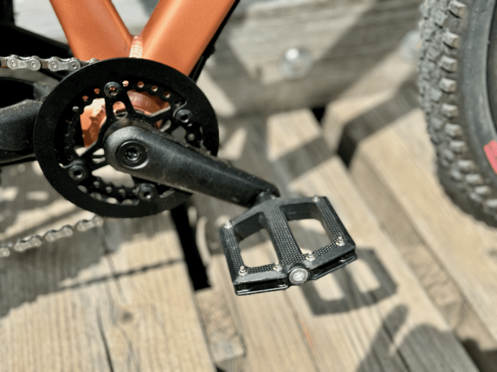 Nahaufnahme der Pedale des woom OFF 4, zeigt die stabilen Plattformpedale mit gutem Grip.
